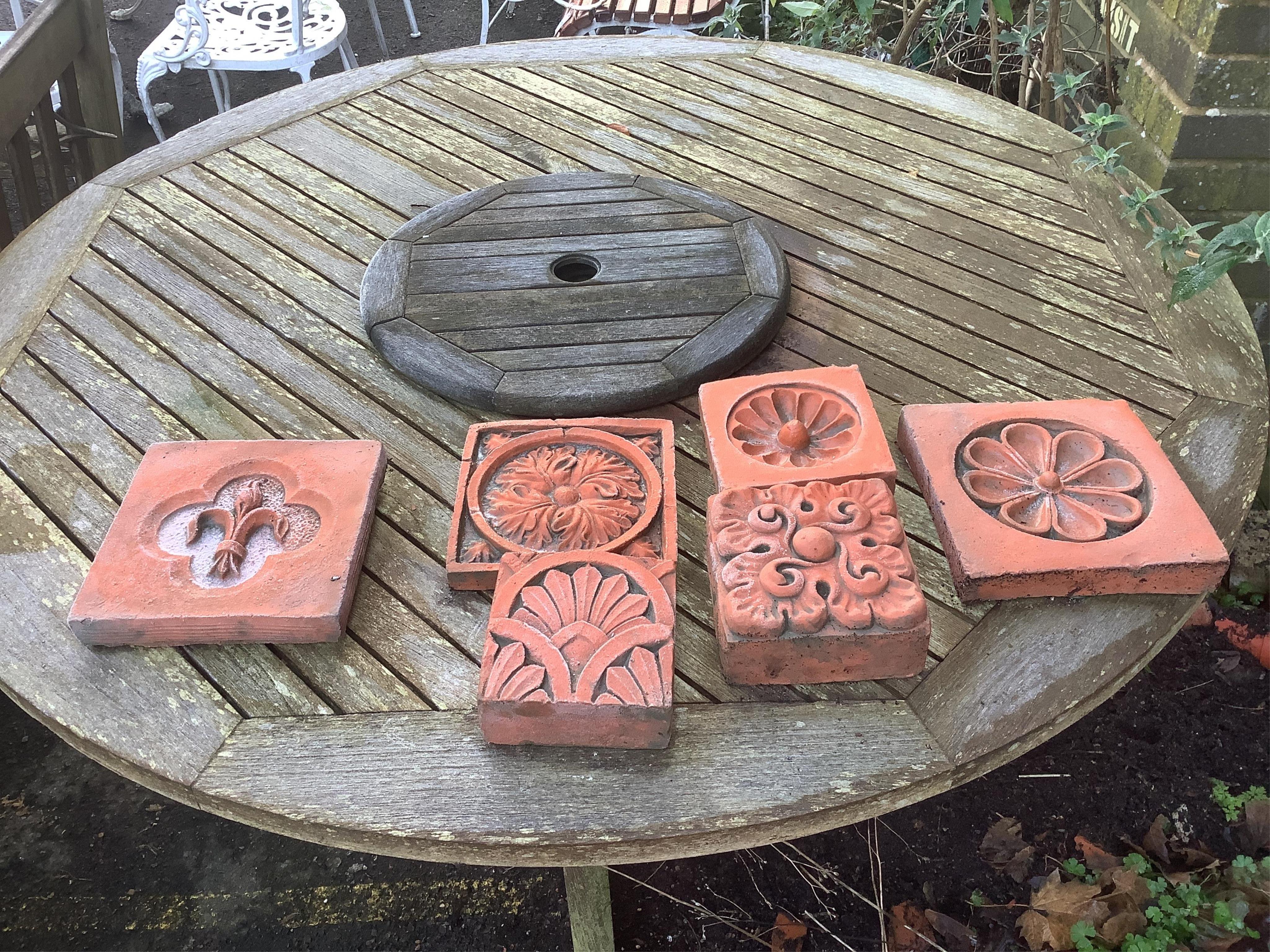 Six terracotta decorative tiles, largest width 21cm. Condition - fair